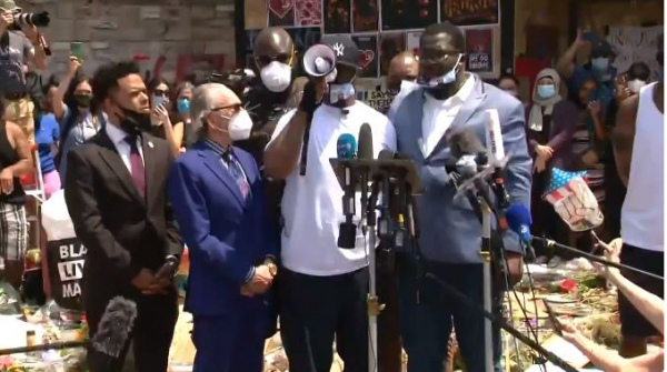 테렌스 플로이드가 확성기를 들고 시위대를 향해 말하고 있다.