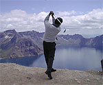 백두산 천지에서 스윙 포즈를 취한 International Golf Instructor Bill H.Kim