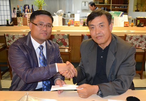 오레곤 선교교회 주환준 목사(좌)에게 선교비를 전달하는 양성환 목사(우)