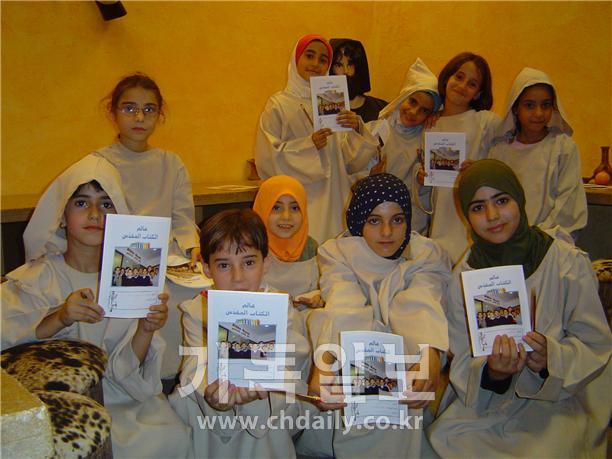 ▲레바논성서공회에서 성경을 기증받은 시리아 어린이들이 기쁜 표정으로 성서(성경)를 보여주고 있다.  ©자료사진=대한성서공회 제공