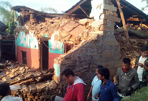 부서진 가옥들 사이로 사람들이 지나가고 있다. 이 지역은 네팔 고르카(Gorkha)시 제4구(Ward)에 위치한 파슬랑(Paslang) 마을로, 진원지 근처의 지역 본부에서 약 3km 떨어진 곳에 위치해 있다. ⓒ월드비전 제공